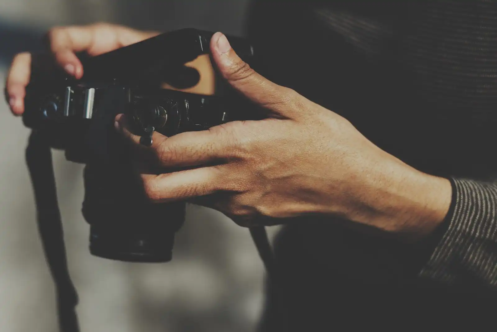 closeup hands checking film camera scaled