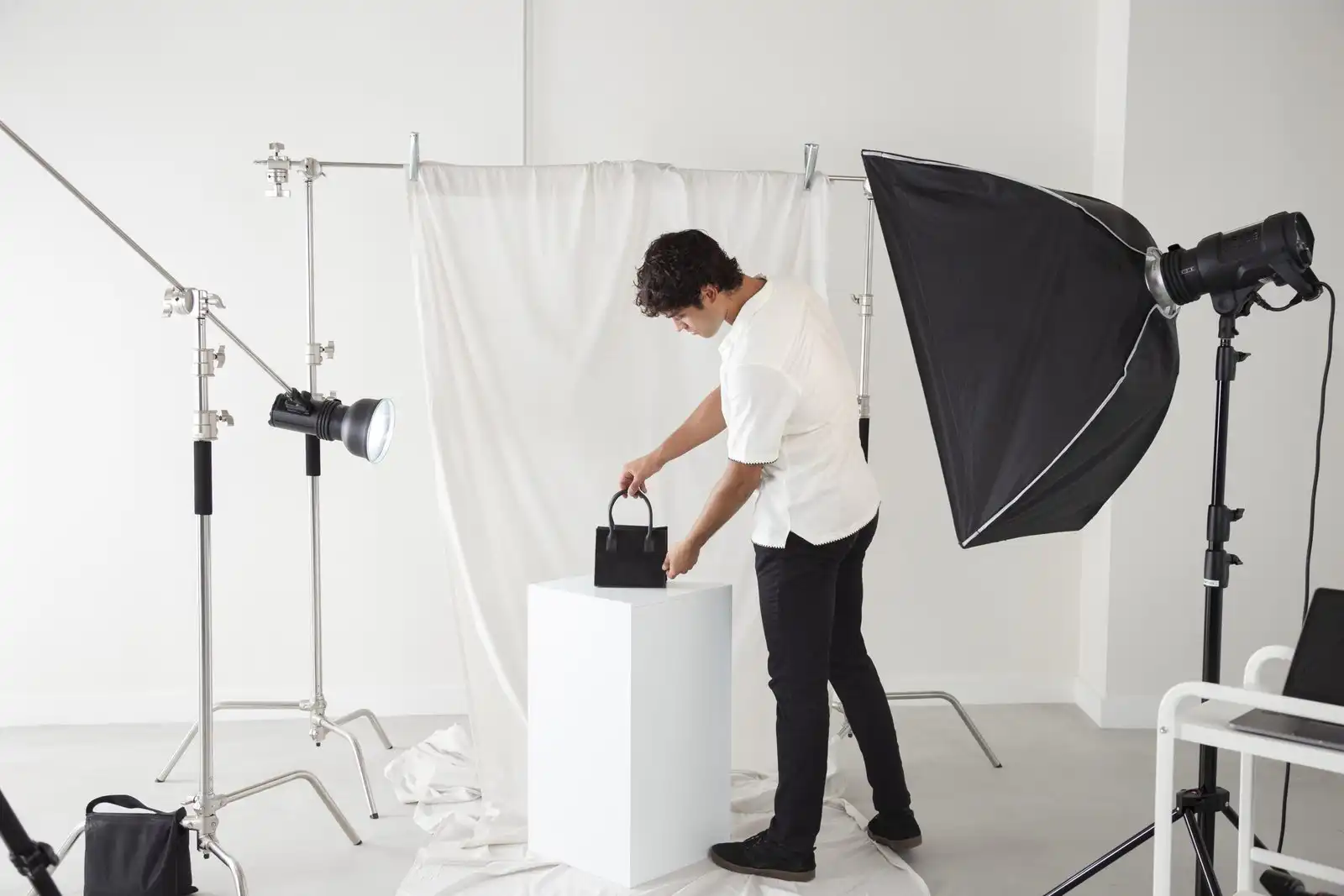 young man working his photography studio scaled